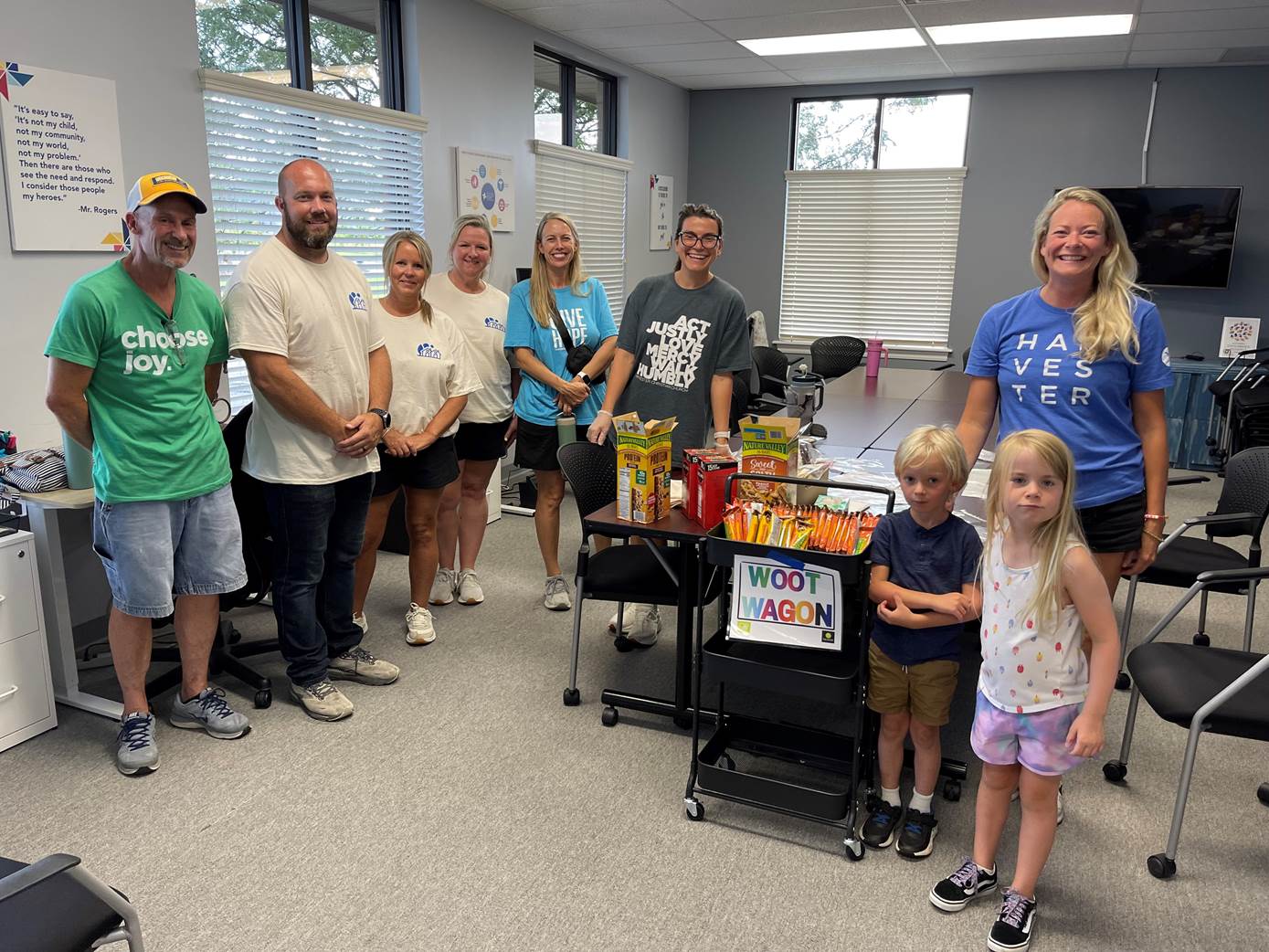 HCC volunteers and staff at the Child Advocacy Center with the Woot Wagon cart of donated snacks and supplies