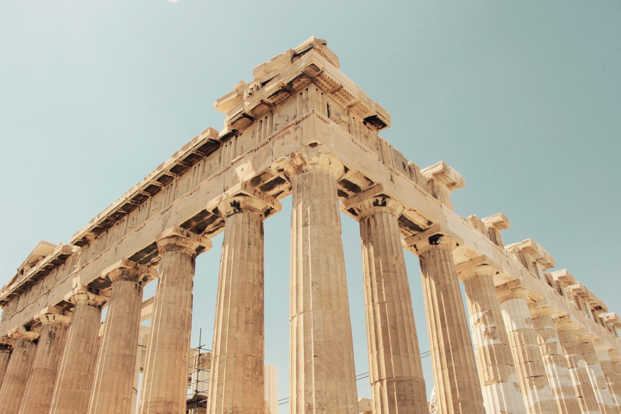 Ancient Greek temple columns of the Parthenon against a blue sky