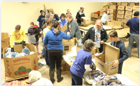 Volunteers packing Thanksgiving food boxes at the No Hunger Holiday event